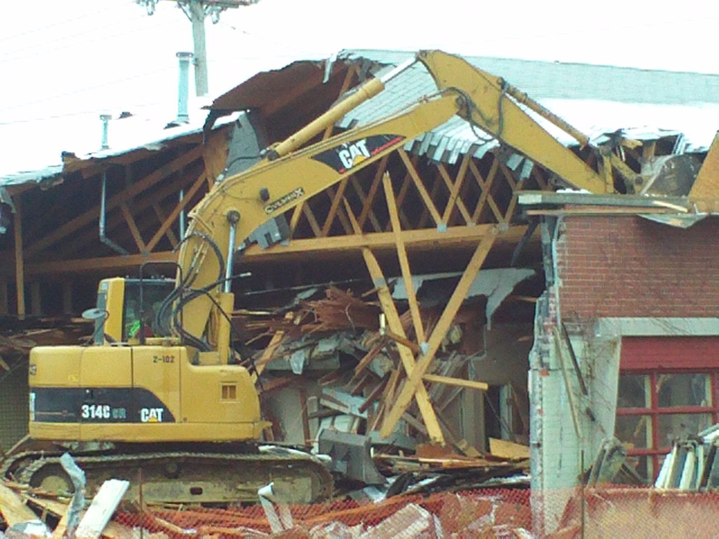 Structural demolition with excavator